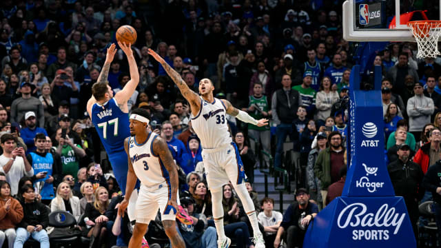 Dallas Mavericks guard Luka Doncic (77) makes a jump shot over Washington Wizards forward Kyle Kuzma (33) during the fourth quarter at the American Airlines Center.